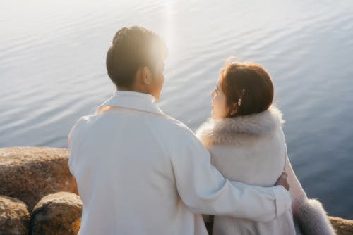 Man and Woman Standing Near Body f Water
