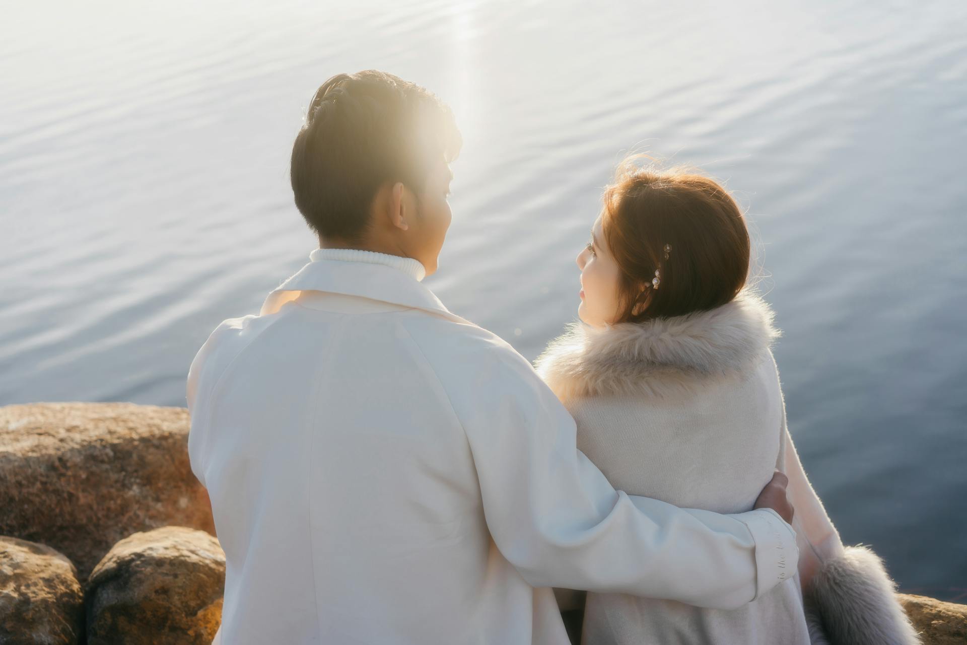 Man and Woman Standing Near Body f Water