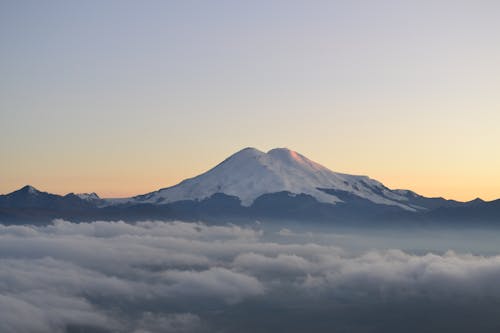 Snow Covered Mountain Above the Clouds