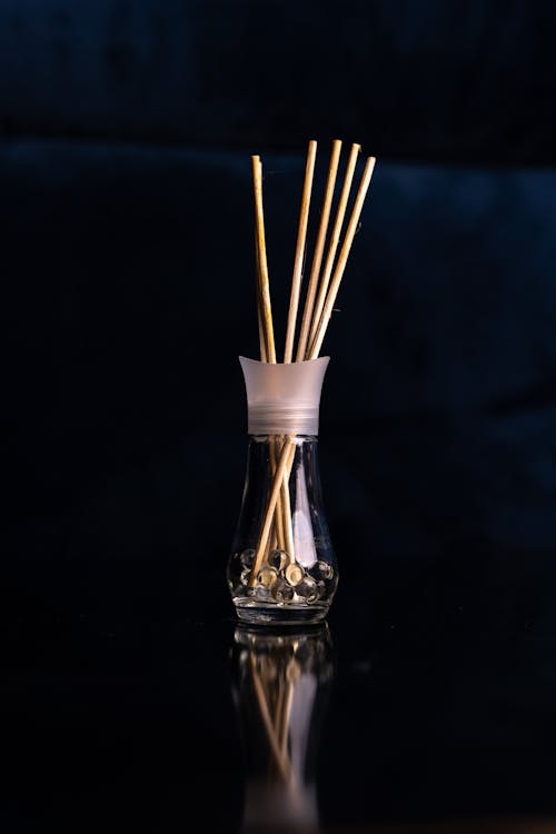 Incense Sticks in a Glass against Black Background