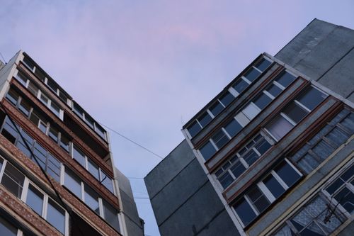 Free Close-up low angle view of urban residential buildings with cloudy sky. Stock Photo