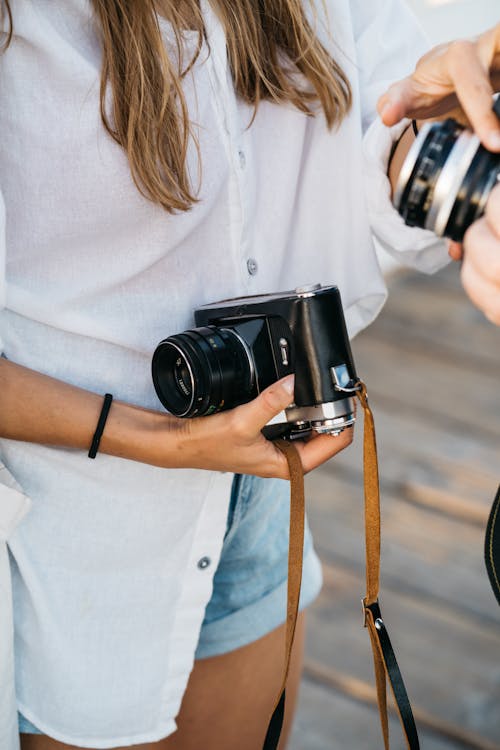 Woman Holding Vintage Cameras