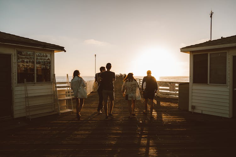 People Walking On Wooden Deck