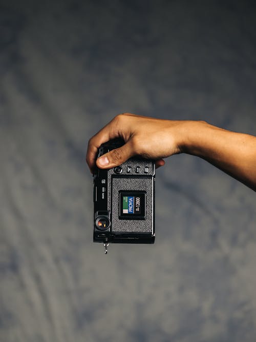 Free Person Holding Black and Gray Camera Stock Photo