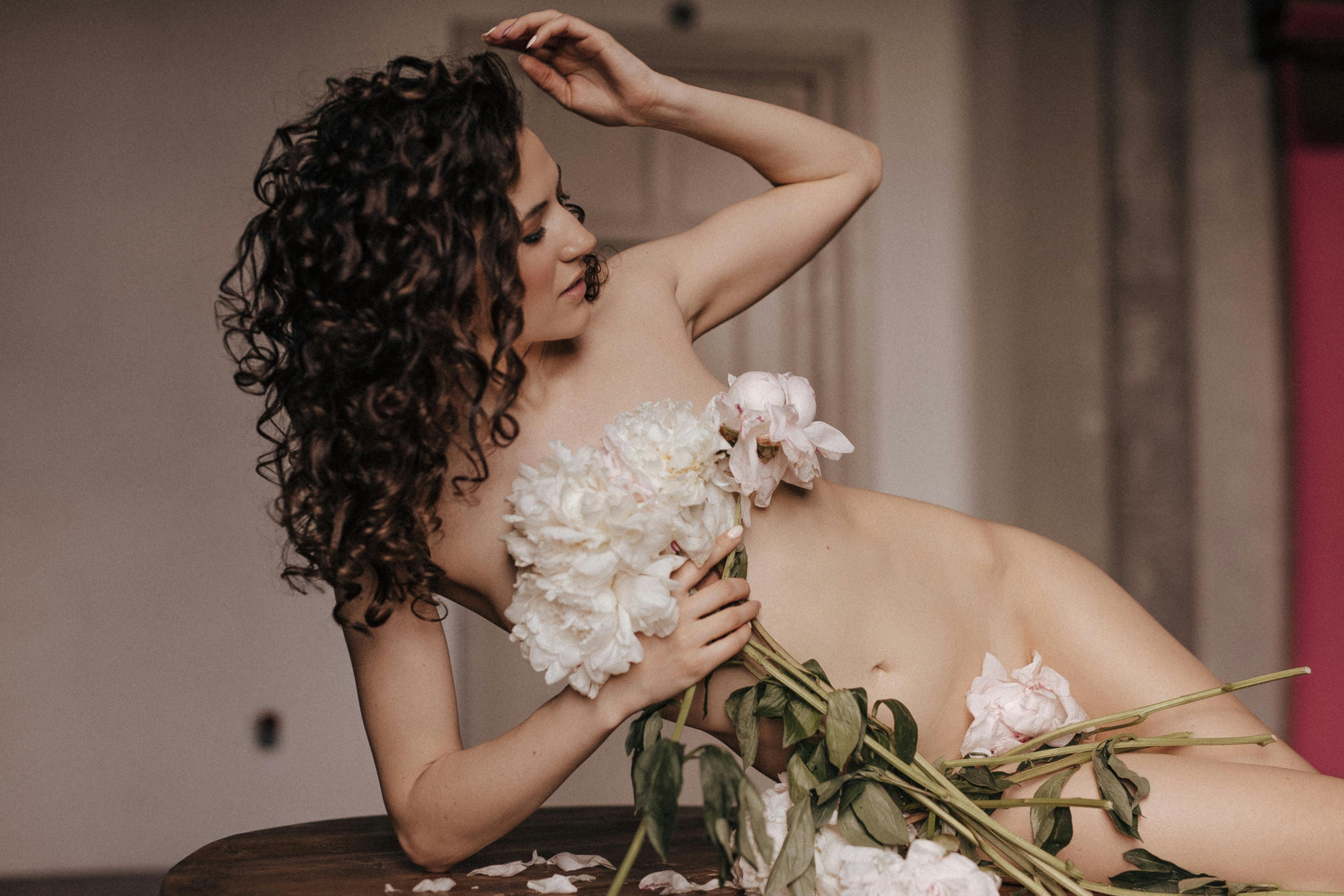 flowers covering the body of naked woman