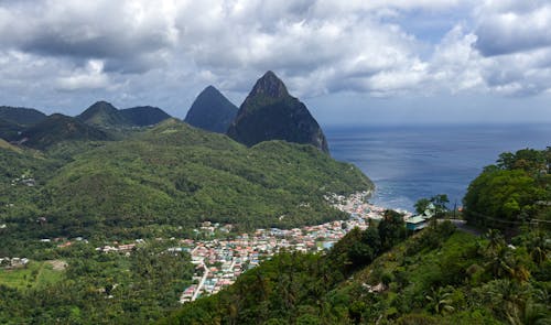 Wide Shot of City Surrounded by Green Mountains