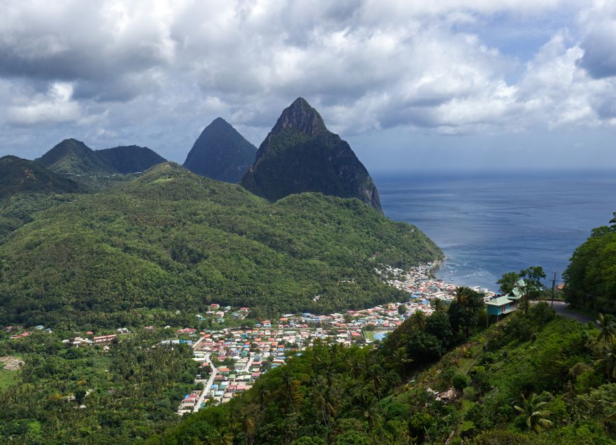 Discover the lush green landscapes and iconic Pitons of Soufriere, Saint Lucia from above.