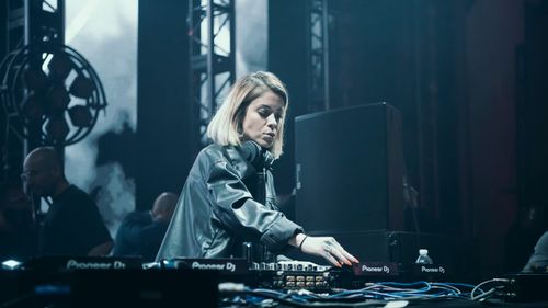 Free Dynamic DJ performance in a vibrant nightclub setting. Stock Photo