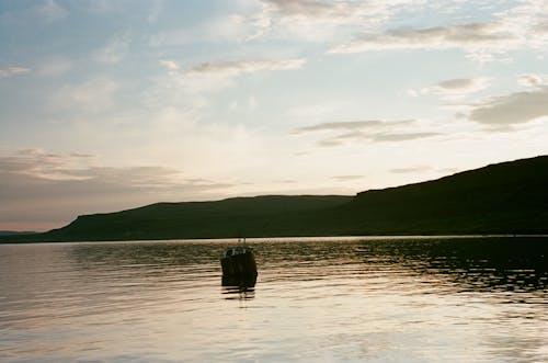 Boat on Water Near Mountain