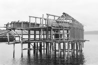 Grayscale Photo of Decaying Wooden House