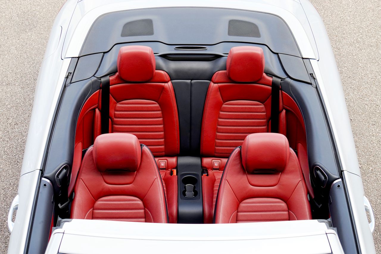 overhead view of a luxurious convertible car with red leather seats an