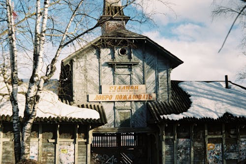 Old Wooden Architecture with Cyrillic Script in Winter