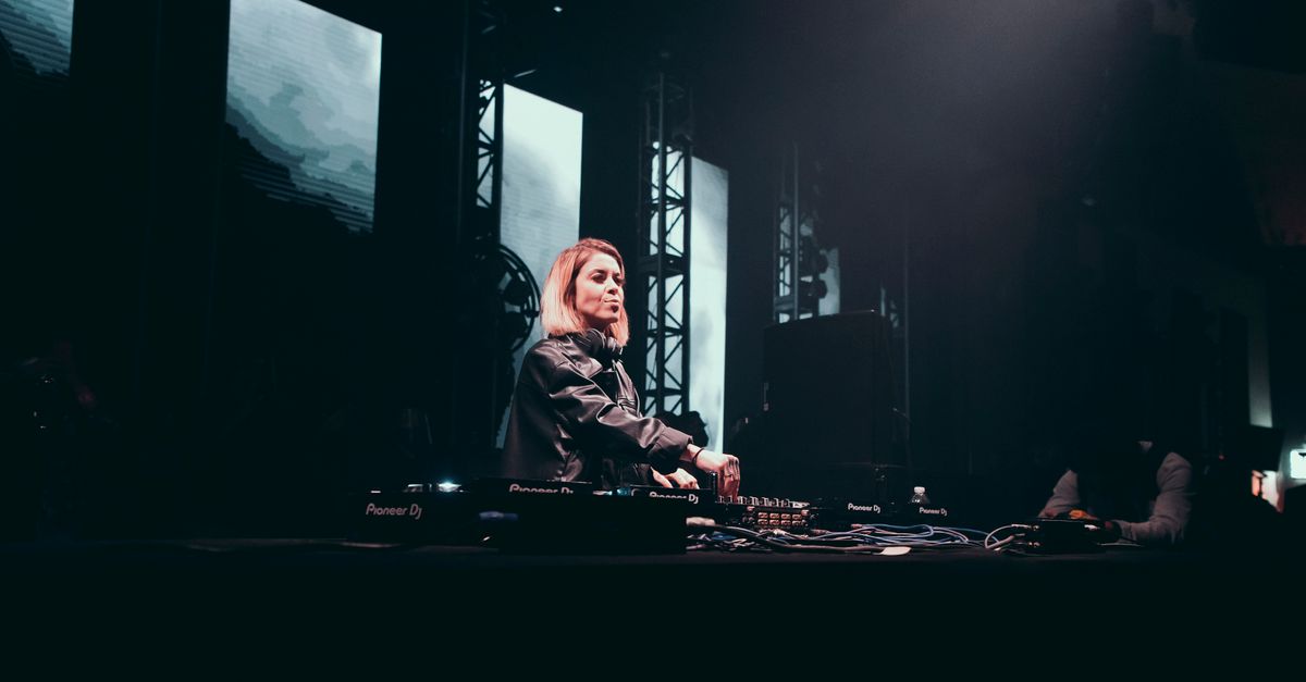 A Woman Djing Onstage at an Event · Free Stock Photo
