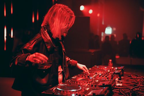 Free A talented DJ in a leather jacket playing electronic music at a lively nightclub. Stock Photo