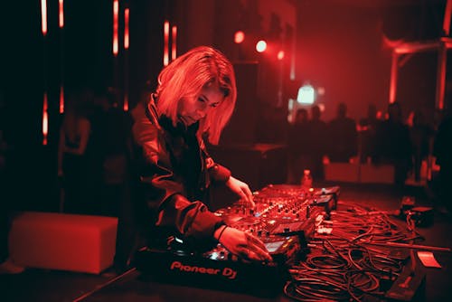 Woman DJ Playing on a Party 
