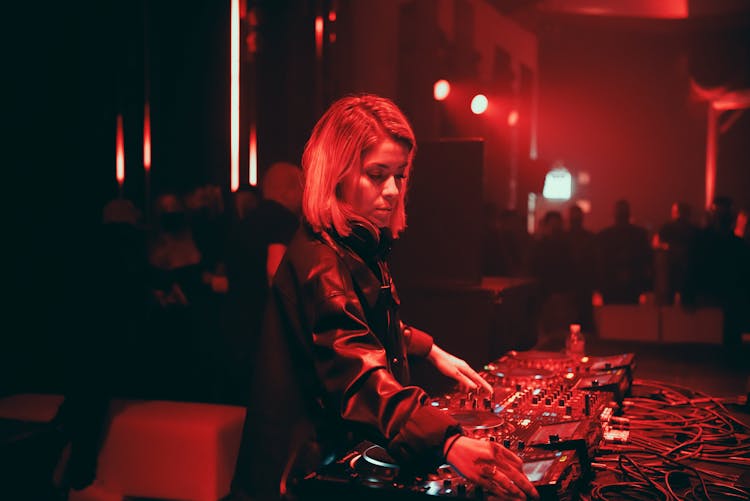 Female Dj Using A DJ Mixer