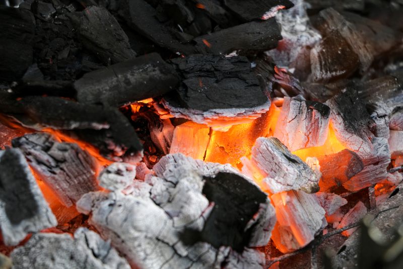 Burning charcoal with a deep orange glow — photo by Diego Sanchez on Pexels