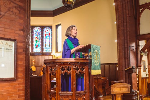 Elderly Womna Standing Behind Podium 