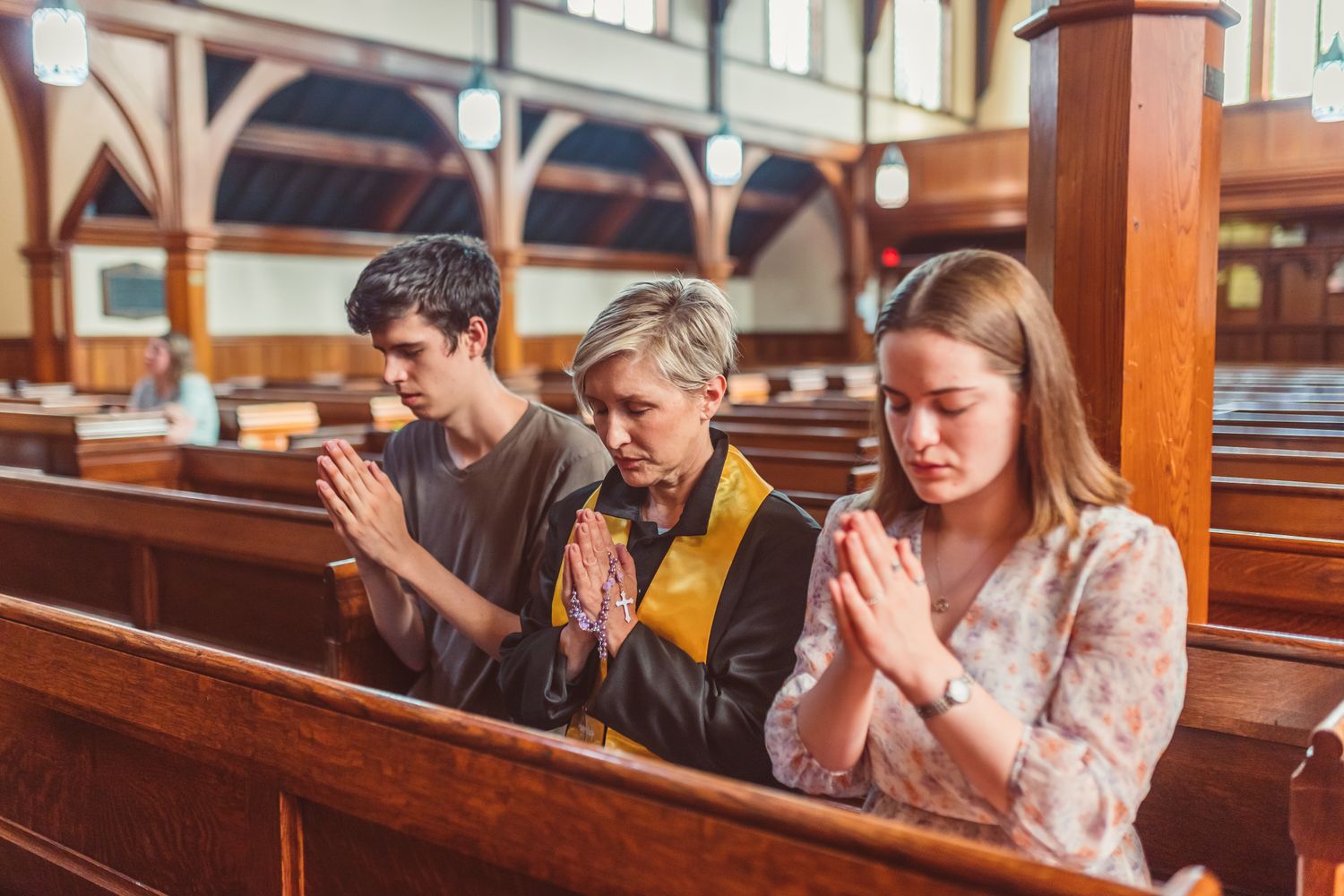 Adults praying together in a serene church interior