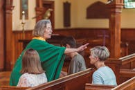 An Elderly Woman Giving Blessing To A Churchgoer