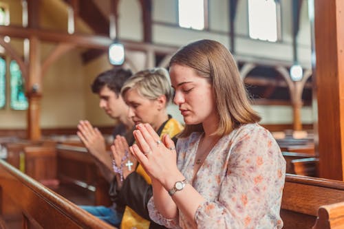 Free Close-Up Shot of People Praying in the Church Stock Photo