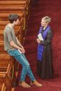 Man Talking to a Clergy