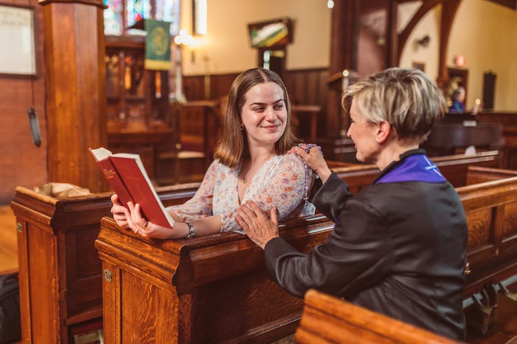 Clergy Holding A Woman's Shoulder