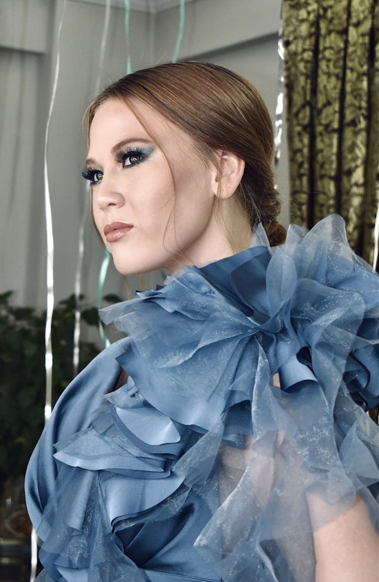 A Woman In Blue Dress With Ruffles