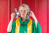 Elderly Woman Holding Torn Paper