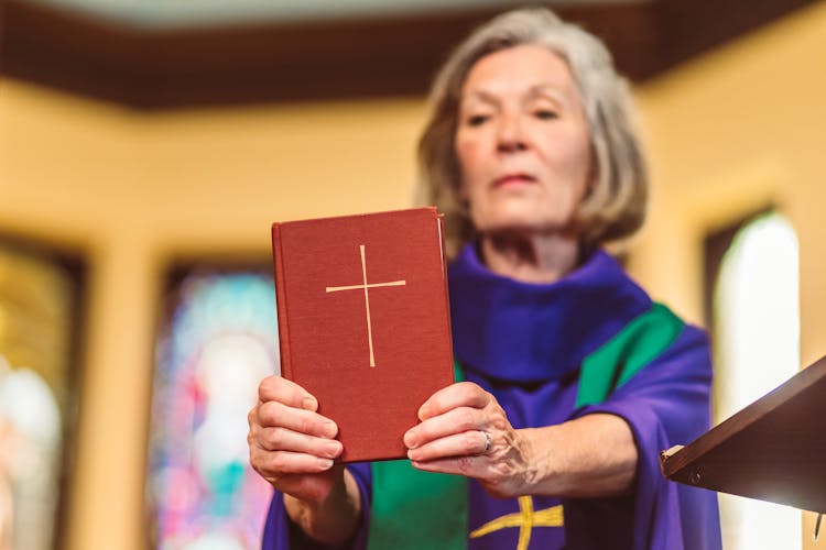 A Woman Holding A Bible