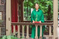 Woman In Green Chasuble Holding A Bible
