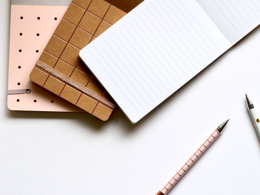 Free Pad With Pens on Table Stock Photo