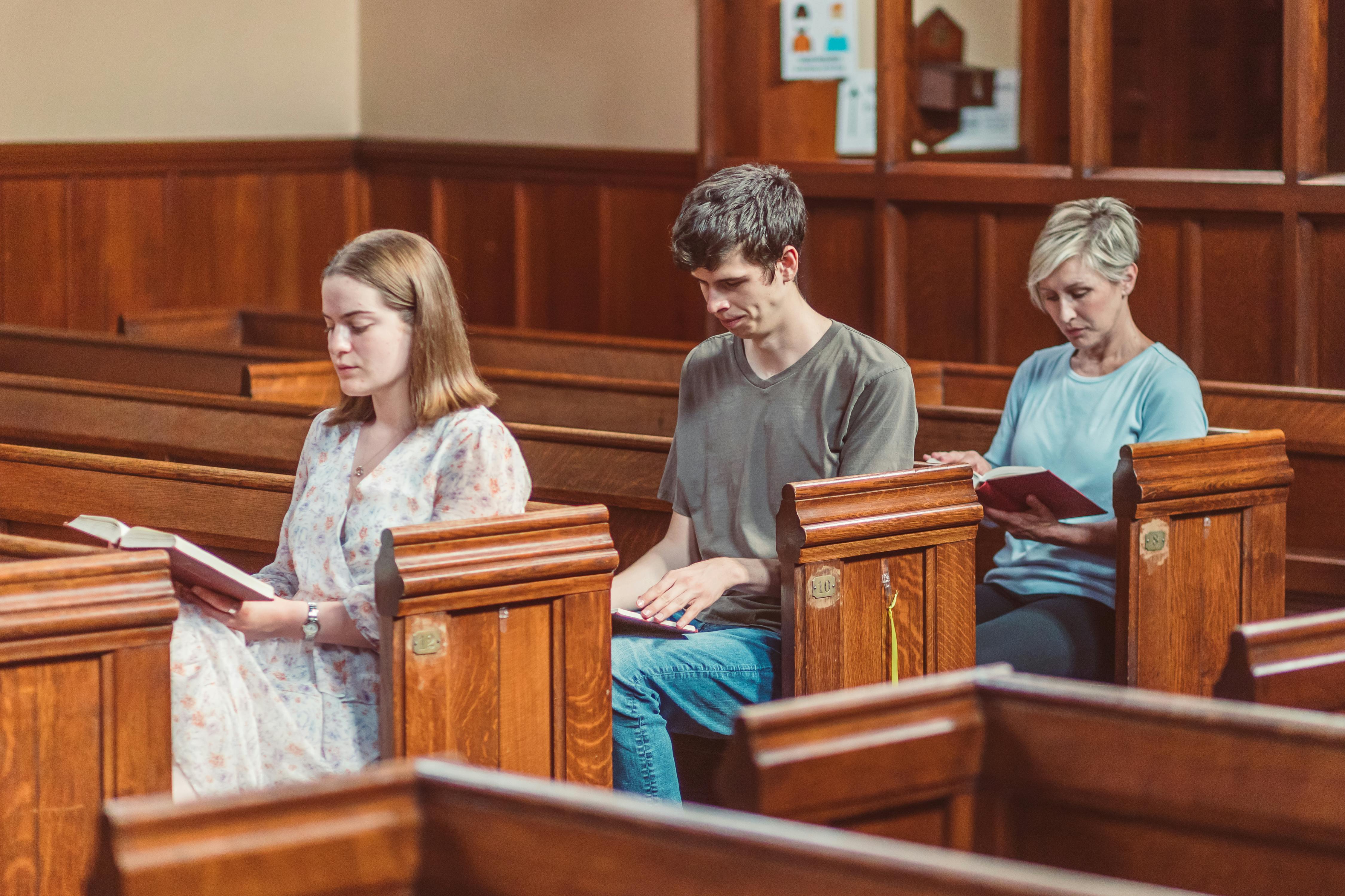 man and women reading a bible inside a church