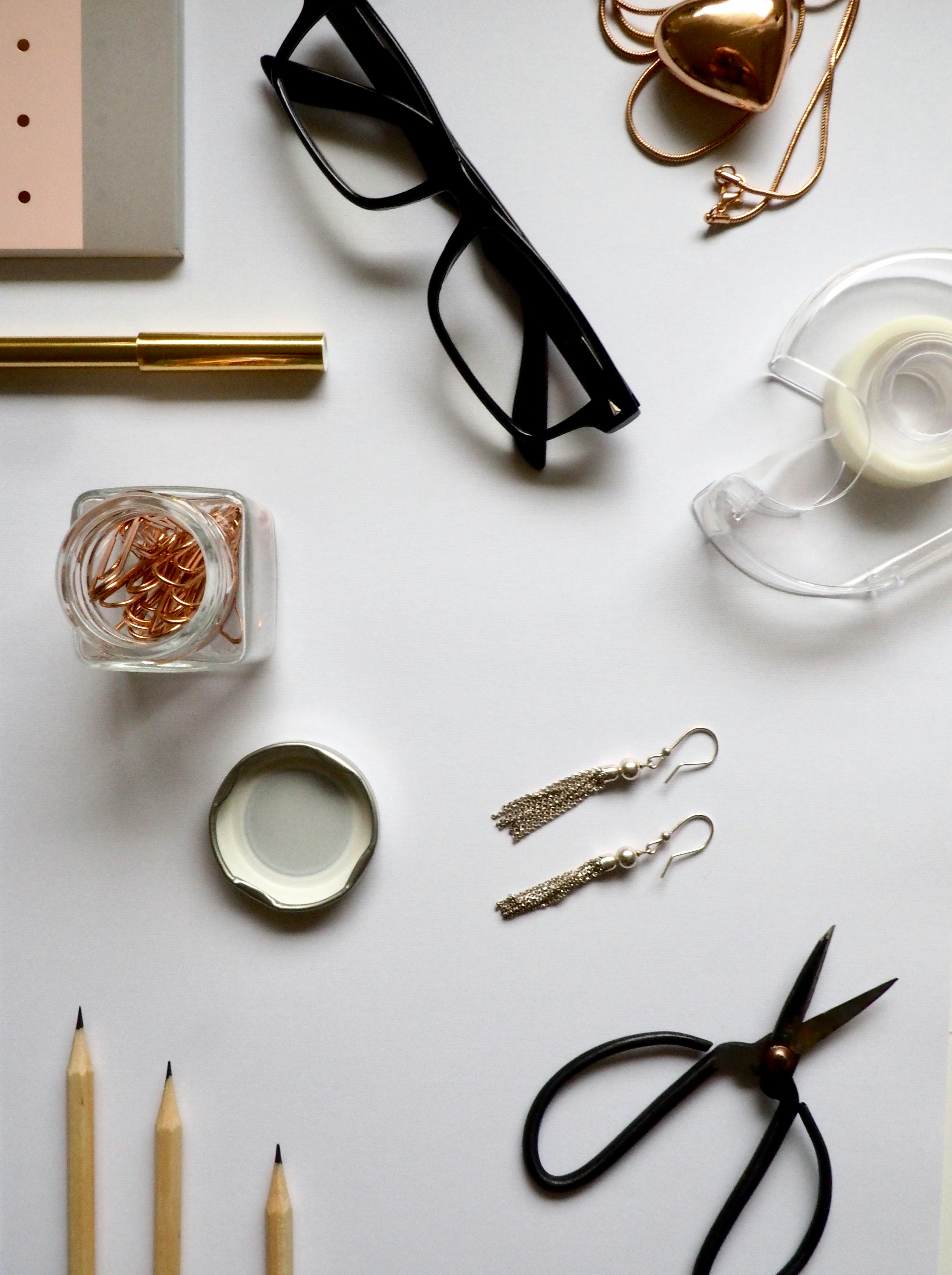 top view photography of white wooden table with personal accessories on top