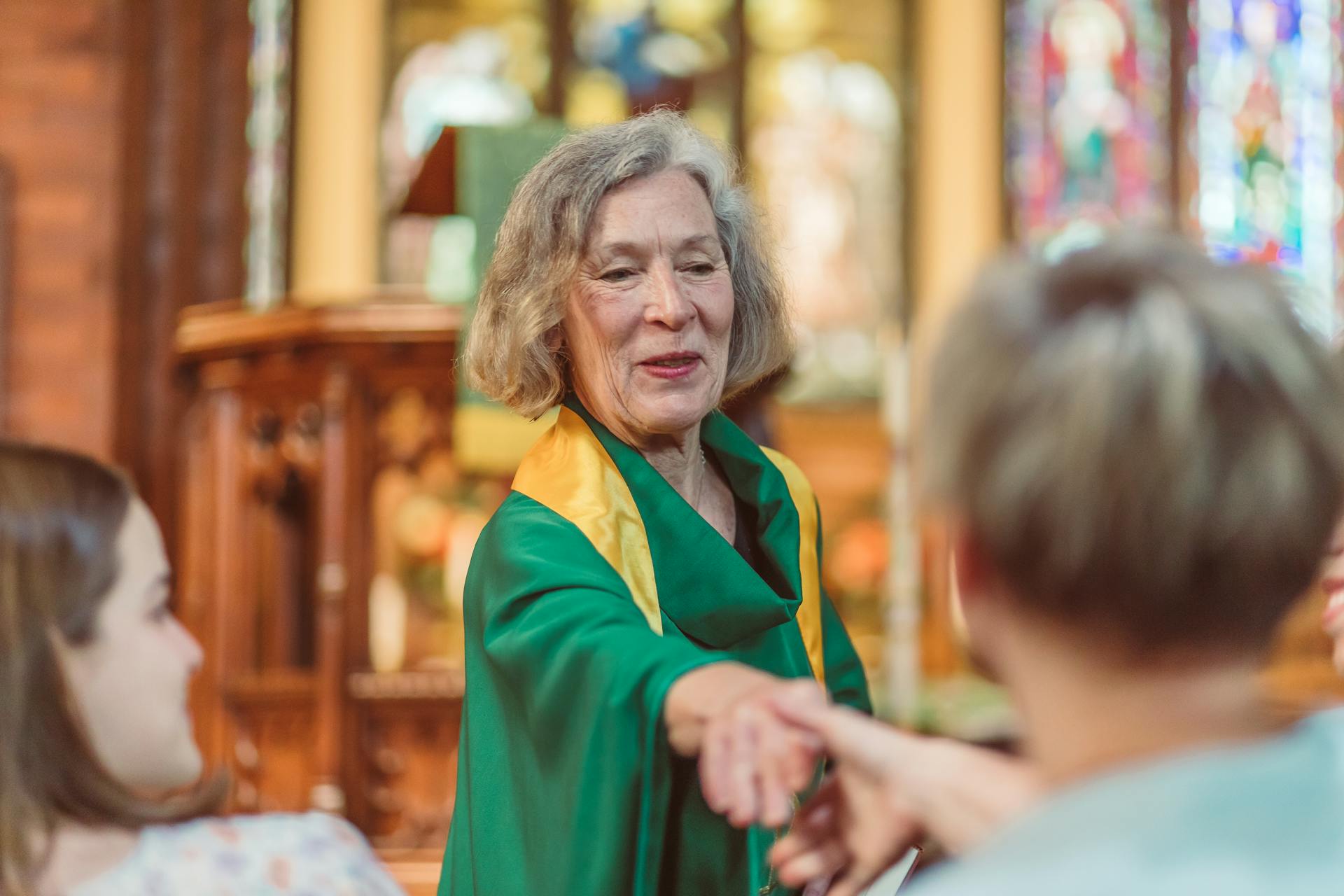 A Woman Priest Shaking the Faithful Hand