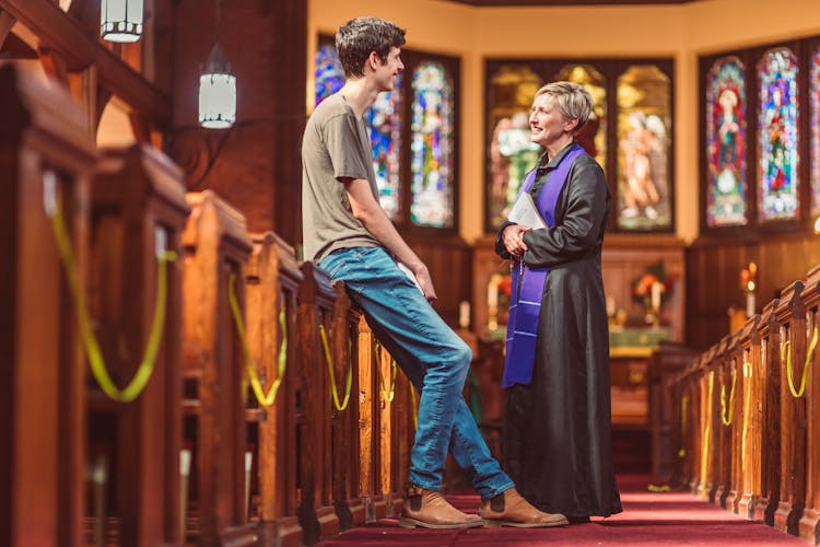 Female Pastor Talking To A Parishioner 