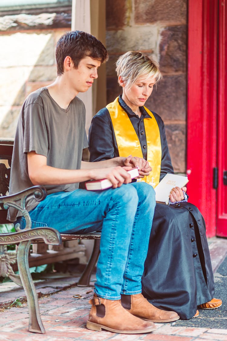 Pastor And A Parishioner Praying Together 