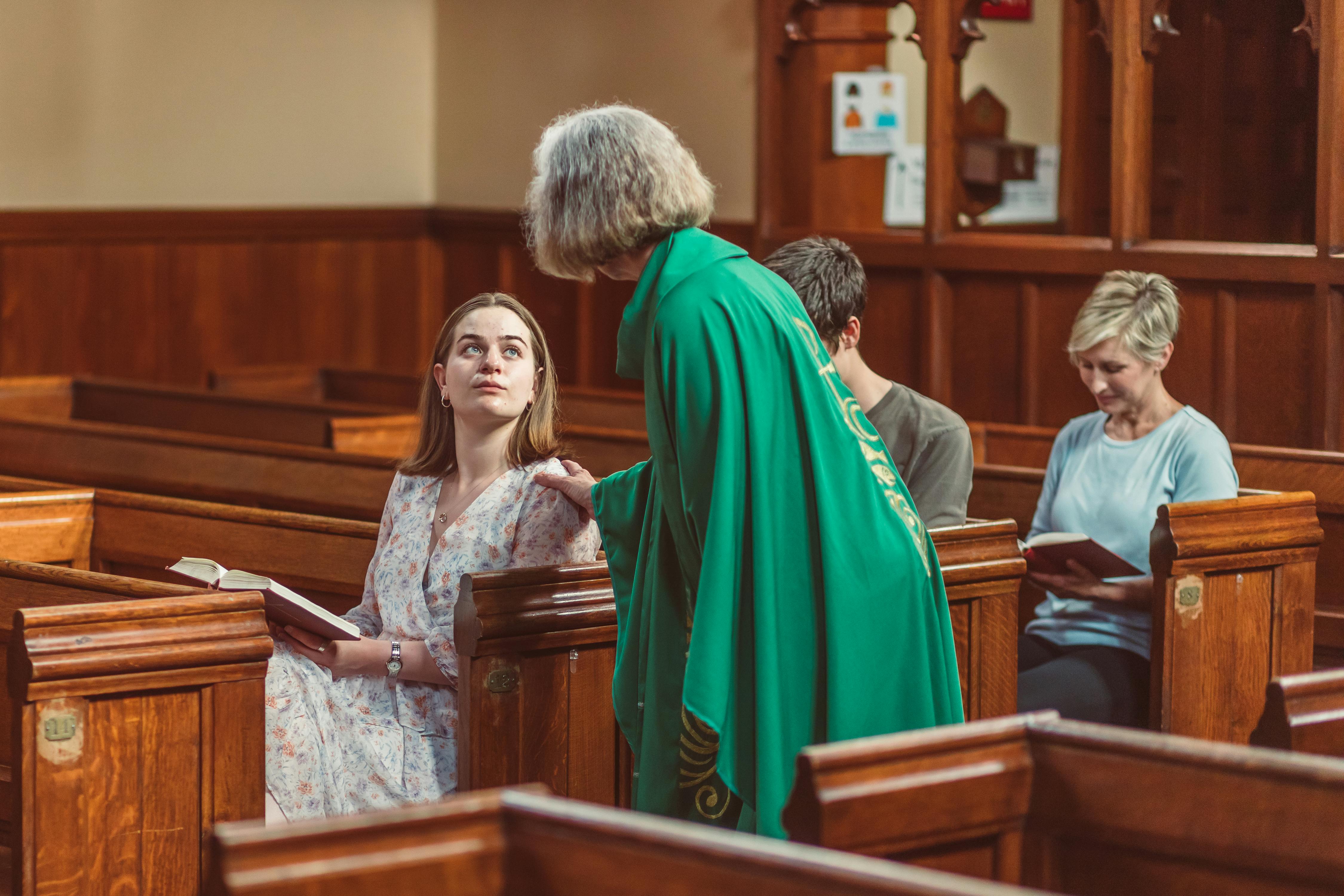 female priest interacts with parishioners