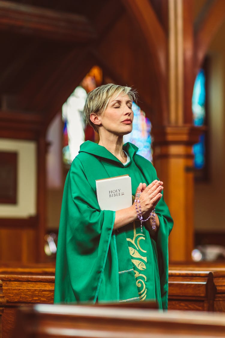 Female Priest Praying Solemnly 