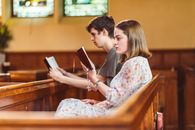 Man and Woman Sitting on Brown Wooden Chair