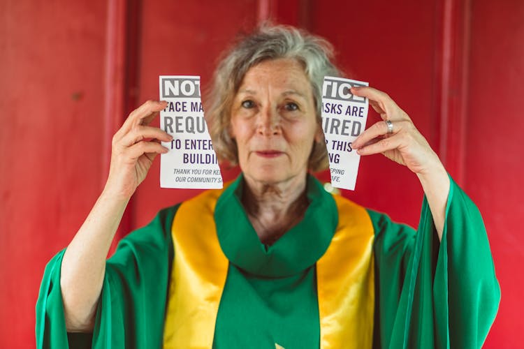 Female Priest Holding A Torn Paper 