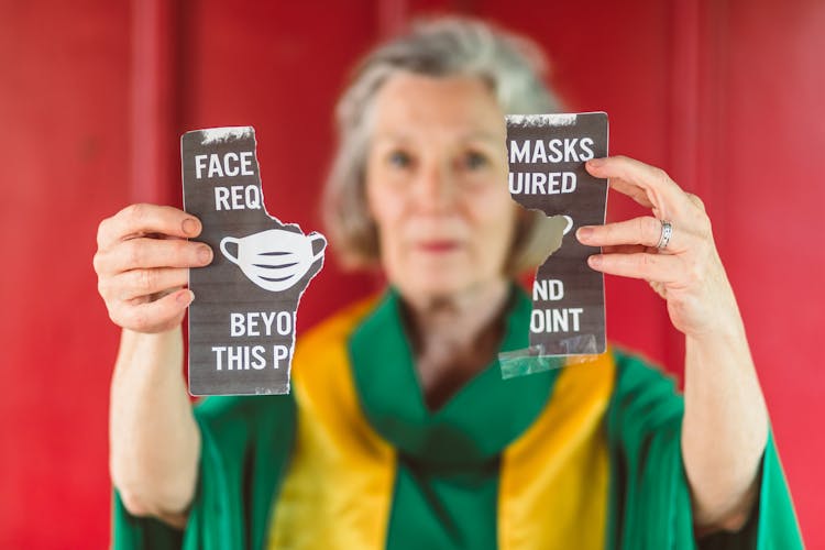 Female Priest Holding A Torn Paper 