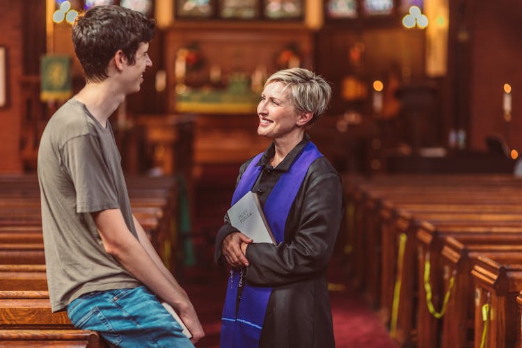 A Female Priest Talking To A Man