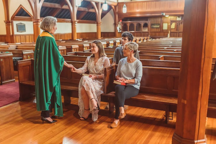 Female Priest Talking To The People Inside The Church