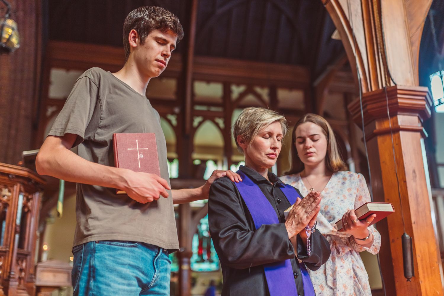 Group of people praying together inside a church