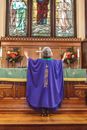 Priestess with Hands Raised Standing on the Altar