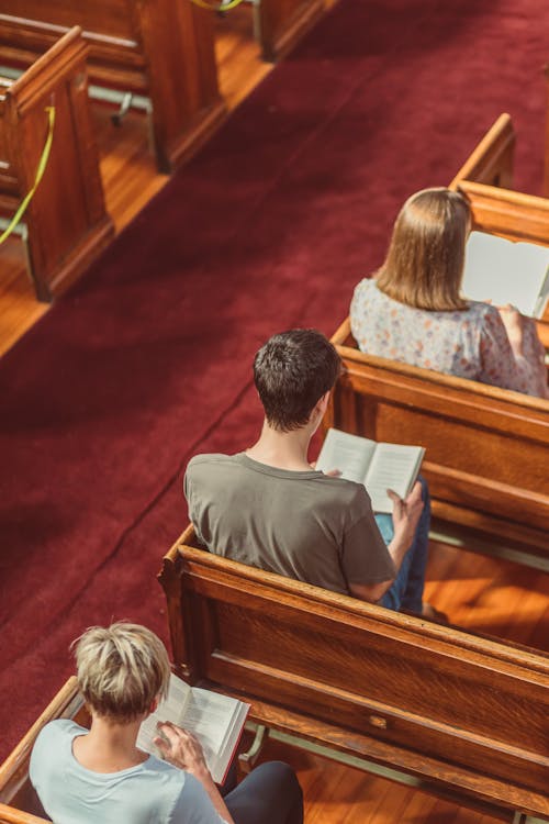 Люди, читающие Библию в церкви