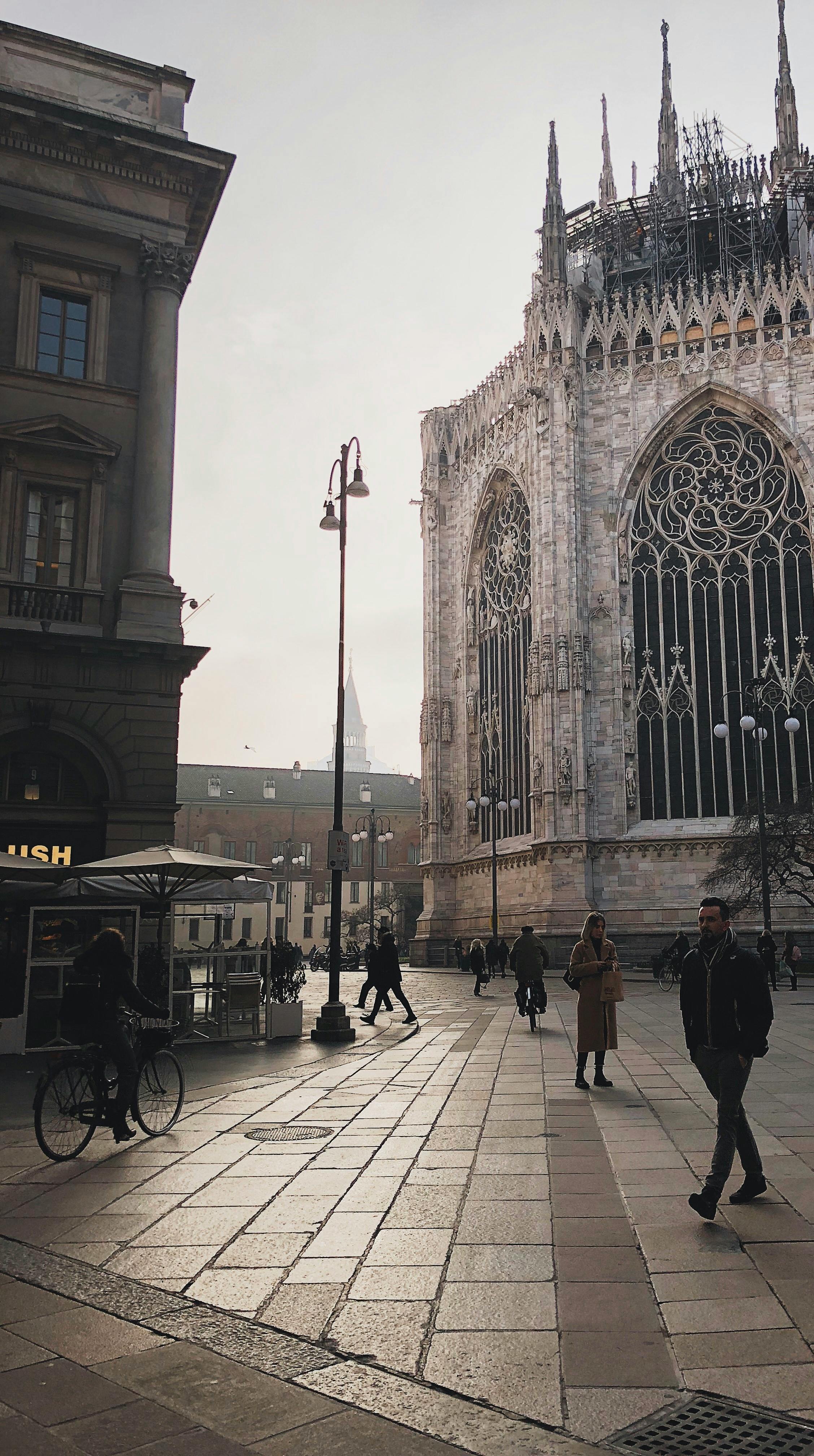 people walking in the street near duomo di milano