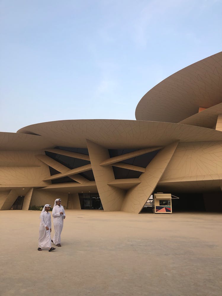 People Walking In Front Of The National Museum Of Qatar