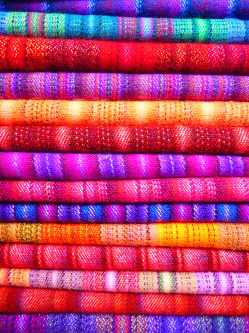 Free Close-up of vibrant and colorful textiles stacked in layers, showcasing intricate patterns and designs. Stock Photo